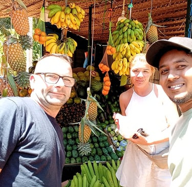 Couple exploring a Sri Lankan vegetable market with their tour driver during a private day tour.