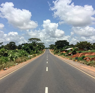 Wide shot of a newly paved road stretching through an urban infrastructure project.