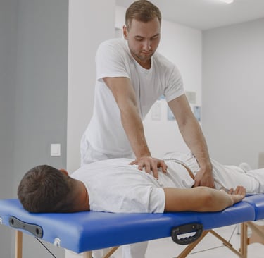 Chiropractor performing lower back adjustment in Brookfield WI