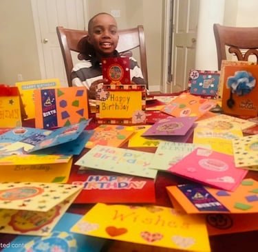 Truman pictured with birthday cards he created for clients of MIFA's Meals on Wheels program.