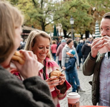 a man and woman eating Leberkas in a city