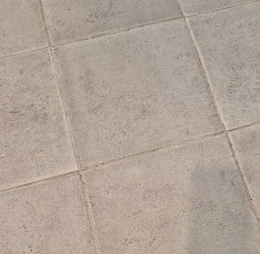 Close-up view of textured grey tiles after laser cleaning