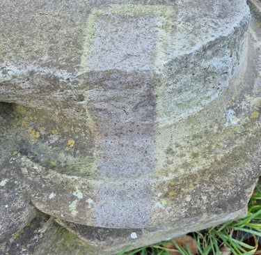 Basalt stone buiding detail partially cleaned with laser cleaner