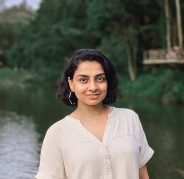 Mita Menezes, relationship and trauma psychologist at Turtle Balance, smiling in a natural outdoors