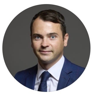 Lewis Cocking Member of Parliament as a man in a suit and tie with a blue tie