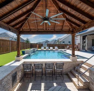 Pool kitchen with a pergola and view to the pool. Estrada Fencing & Outdoors