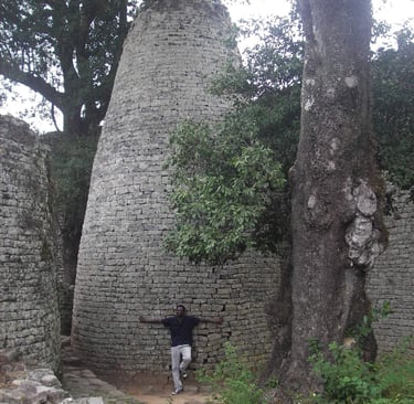 Man leaning on the Great Enclosure tower at Great Zimbabwe