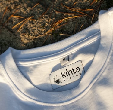 a white t - shirt with a kinta design tag on it