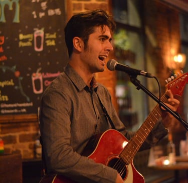 Olly Williams acoustic guitarist performing live music set