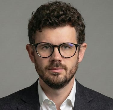 a man with glasses and a suit jacket