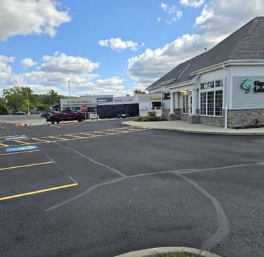 shows a freshly sealcoated and striped bank parking lot in Rocky River