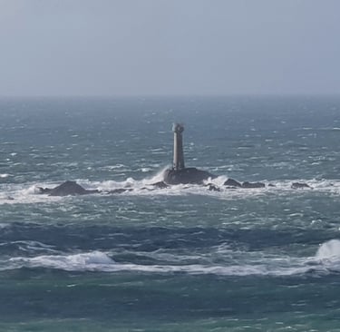Longships lighthouse off Lands End in Cornwall in choppy, stormy seas