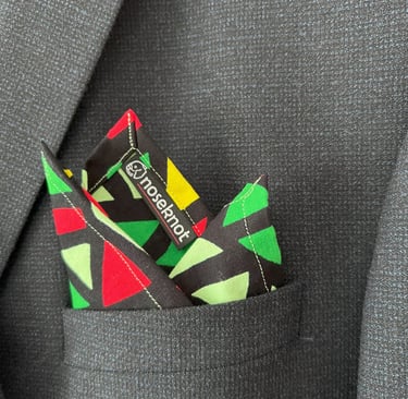 A Noseknot handkerchief showing the Noseknot logo in a suit pocket