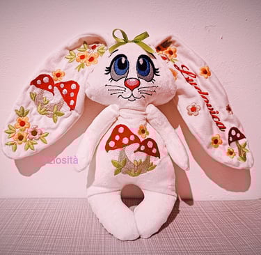 Customized white plush bunny with floral embroidery and red mushrooms on ears and belly.