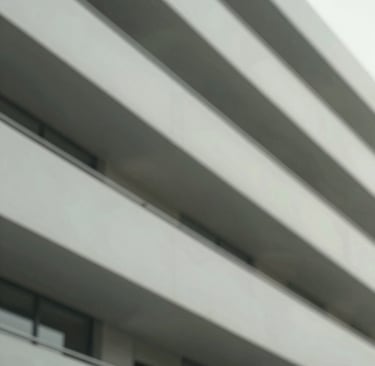 An understated, elegant detail of a modern architectural structure with soft, natural shadows. Incorporates muted tones of #3F5E5C and #A7C5C3. Crisp, clean lines and professional composition.