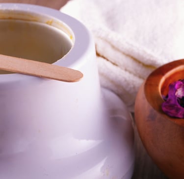 Professional hair removal kit featuring a wax warmer with wooden applicator and towels