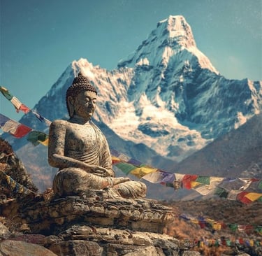 A stone Buddha statue with colorful prayer flags in front of a snow-capped Himalayan mountain.