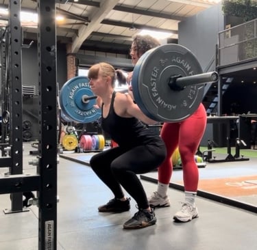A barbell squat during a PT session