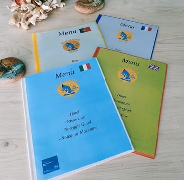 I menu del Big Game Maio disponibili in italiano, inglese, francese e portoghese appoggiati su un ta