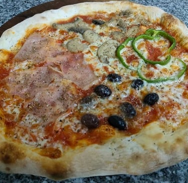 Pizza italiana farcita con prosciutto, funghi e olive, cotta nel forno del ristorante Big Game Maio.