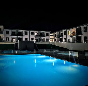 a pool with a pool and a waterfall in the background