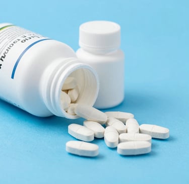 a thermometer, pills, and a bottle on a table