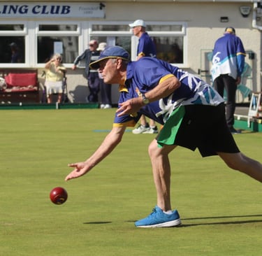 Man bowling on outdoor green