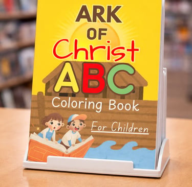 Ark of Christ ABC coloring book for children displayed on a stand in a library.