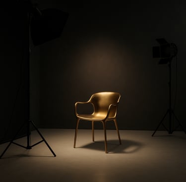 A professional photography studio interior in Kartal, Istanbul. The scene is minimalist and luxurious with dark slate black walls, soft off-white floor, and a single metallic gold designer chair under a soft spotlight.