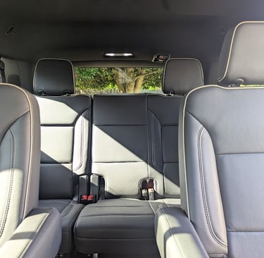 Interior view of a modern SUV showing gray leather car seats with premium stitching.