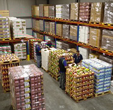 Close-up of hands scanning and processing B2B orders at our modern pick & pack station.