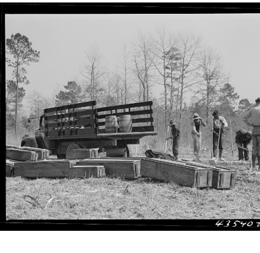 Digging new graves for a cemetery being moved out of Santee-Cooper basin. Near Bonneau SC