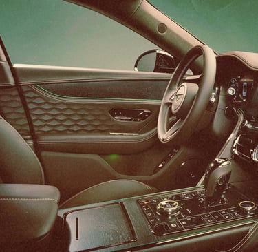 Luxury car interior with quilted leather seats and a digital dashboard display.