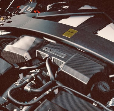 Detailed close-up of a high-performance Brabus carbon fiber engine bay and strut bar.