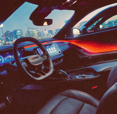 Modern luxury car interior featuring red ambient lighting, digital dashboard, and leather seats at night.