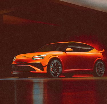 Orange Genesis GV60 Magma concept electric SUV parked in a dimly lit modern garage.