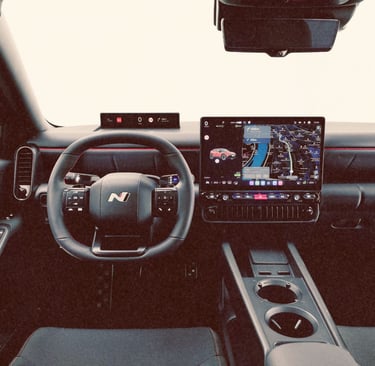 Modern interior of a Hyundai Ioniq 3 N featuring a digital dashboard and navigation screen.