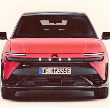 Front view of a red Hyundai IONIQ 3 N Line electric car with pixel LED headlights.