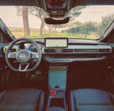 Interior view of a modern Jeep Avenger electric SUV dashboard with digital cockpit and infotainment system.