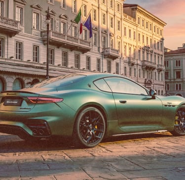 A green Maserati GranTurismo luxury sports car parked in a historic Italian city square at sunset.