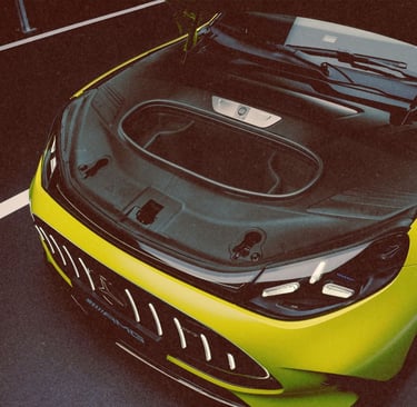 High-angle view of a lime green Mercedes-AMG electric car with its front trunk storage open.