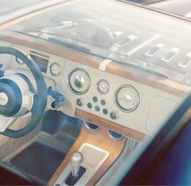 Luxury vintage car interior with a wooden dashboard and classic round analog gauges.