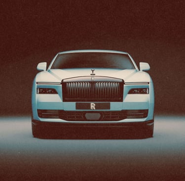 Front view of a white Rolls-Royce luxury sedan featuring its signature grille and Spirit of Ecstasy hood ornament.