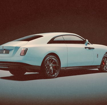 A sleek white Rolls-Royce Spectre luxury electric coupe shown from a rear three-quarter view.