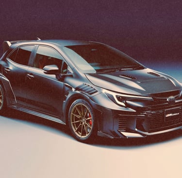 Matte grey Toyota GRMN Corolla with gold wheels and carbon fiber hood vents in a studio setting.