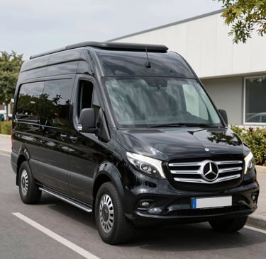 A sleek black luxury sedan parked in front of a modern Toronto skyline at dusk.