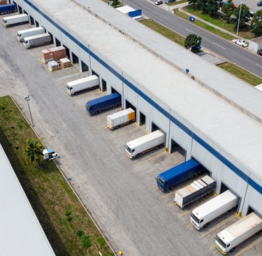 white sedan parked beside white van