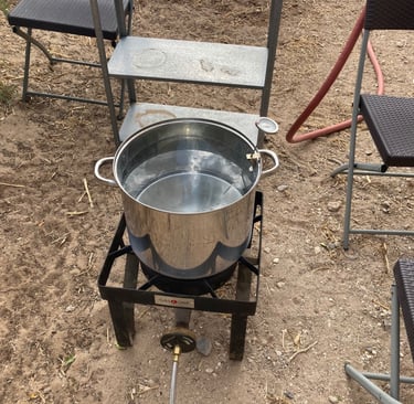 Outdoor propane burner used to heat water to wash wool.