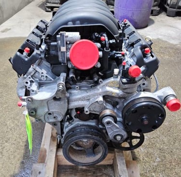 Rebuilt LS V8 engine assembly on a wooden pallet for automotive performance upgrades.