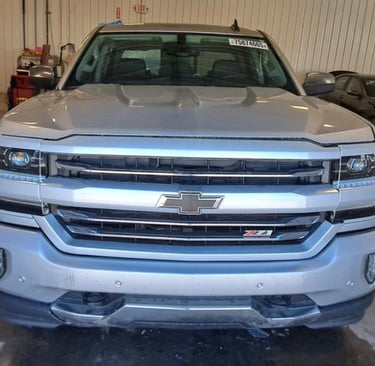 Front view of a silver Chevrolet Silverado Z71 pickup truck parked in a garage.